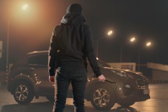 close up on man trying to break into a car 1