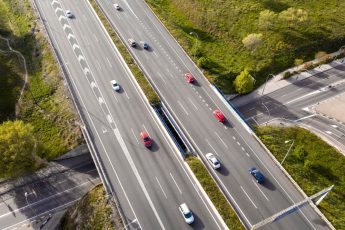 cars driving on street aerial view